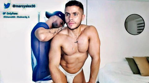 Muscular hunk in white briefs embraced by shirtless guy in sheer top, OnlyFans tease