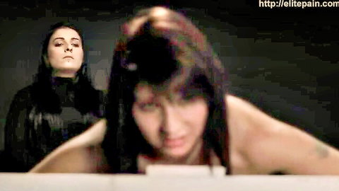 Brunette bent over for whipping and electrocution torture by dark-haired dominatrix, BDSM scene