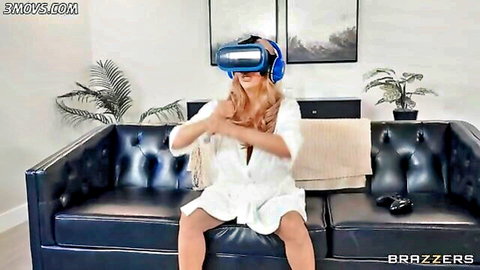 Alexis Fawx in VR headset, seductive pose in open white dress, Brazzers MILF tease