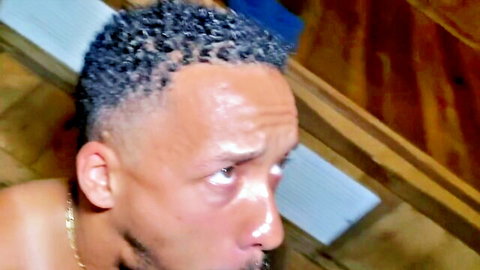 Ebony daddy Tommy Bluezz shirtless in bathhouse, intense gaze