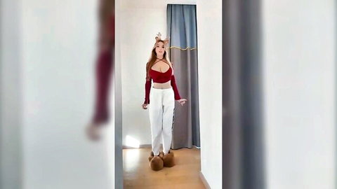 Sexy Asian girlfriend in low-cut red crop top and white pants posing