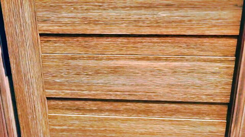 Close-up of textured wooden slats on a louvered door or blind.