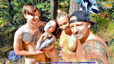 Tattooed amateurs in outdoor group sex scene in woods