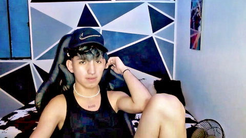 Sexy white twink in Nike cap and tank top spreads legs teasing on solo webcam