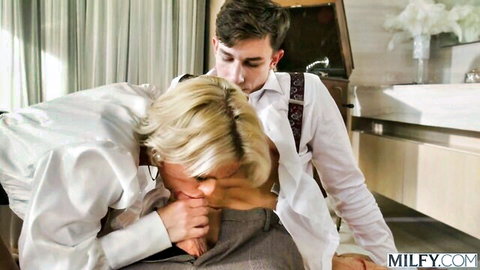 Blonde MILF passionately French kissing young stud in suspenders bathroom