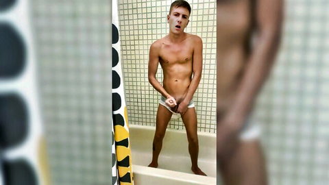Young twunk pees on himself in bathtub, ejaculates on trunks