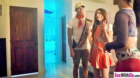 Boy scout stands between sexy stepsister in orange mini skirt and sheer-top babe teasing in room