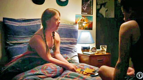 Ginger with medium tits topless eating chips on bed next to shirtless tattooed guy