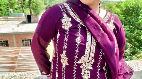 Sexy Indian Bhabhi in purple embroidered salwar kameez posing outdoors