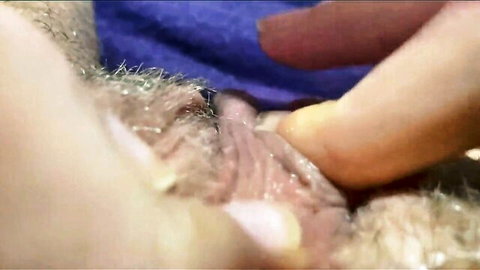 Close-up lesbian fingering hairy pussy for intense clitoral orgasm