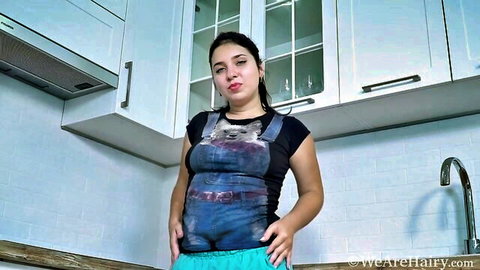 Brunette babe in soaked denim overalls teasing wet crotch in kitchen