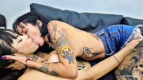 Tattooed Hispanic lesbians deep kissing passionately, topless embrace