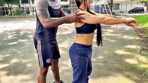 Silvana Lee stretches with black coach in interracial fitness scene