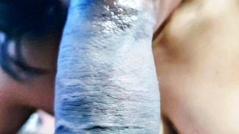 Muscular hand gripping shiny oiled South Asian woman's thick thigh closeup