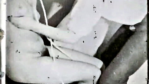 Vintage 1960s flagellation BDSM scene with nude woman bent over