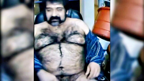 Big hairy bear man exposing furry chest and belly