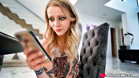 Blonde tattooed stepsister in floral dress surprised by phone message