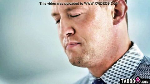Close-up of handsome Caucasian man in suit with stubble, contemplative gaze