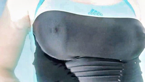 Trans woman in tight Adidas one-piece swimsuit teasing in jacuzzi