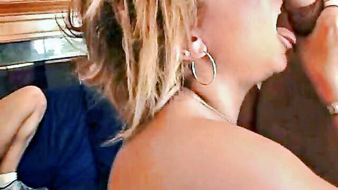 Blonde woman topless, passionately kissed on neck in gangbang scene
