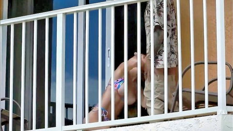 Bikini woman bent over balcony railing getting fucked doggy style from behind outdoors