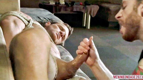 Bound muscular man in gay bondage with partner holding hand, part 2 London