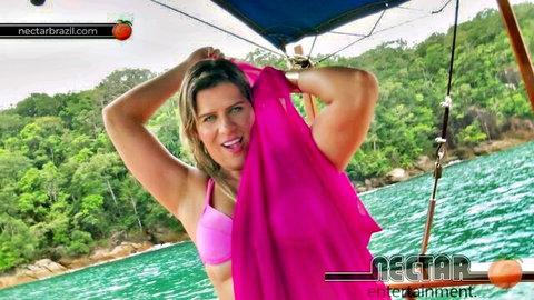 Tanned blonde babe with big tits in pink bikini top teases on tropical boat