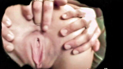 Close-up of hands spreading open shaved pink pussy lips exposing wet vaginal entrance