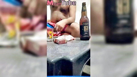 Topless South Asian babe exposes perky tits while smoking cigarette next to beer bottle