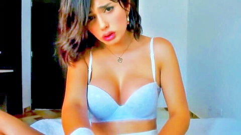 Seductive shemale in white lace bra showing cleavage on webcam