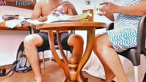 Vilashini in wavy blue dress sits with topless man, intimate table tease