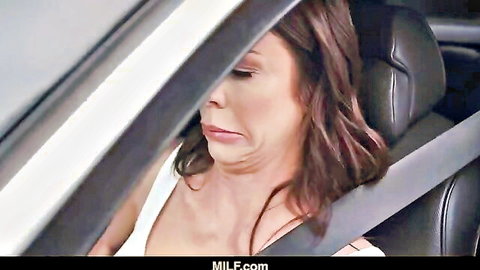 Alexis Fawx as sexy MILF in car, white top and seatbelt, intense gaze