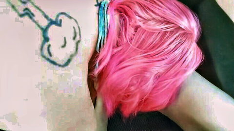 Pink-haired girl with cartoon key tattoo on thigh pulls aside pink thong exposing bare pussy