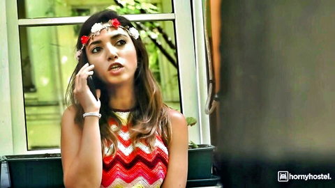 Mark Aurel in colorful zigzag dress, floral headband, seductive phone call in hotel romance