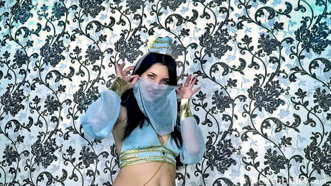 Tanita as seductive genie in sheer blue harem outfit, teasing pose