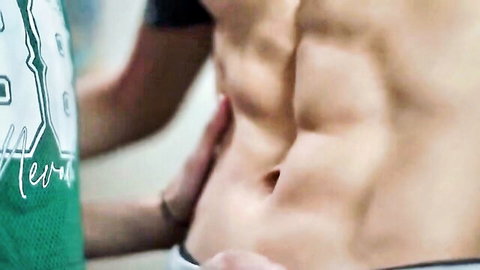 Two muscular friends intimately touching defined abs in close-up
