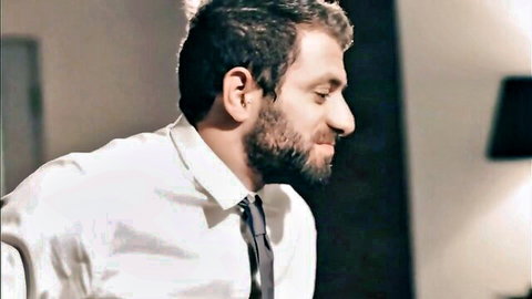 Handsome bearded man in white shirt and tie, seductive side profile smile
