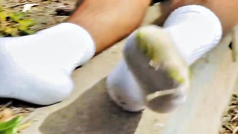 Xander blond skater model's worn white socked feet outdoors
