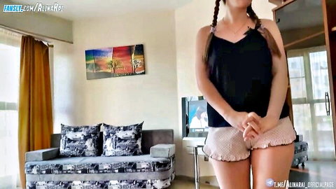 Alina Rai in black camisole and pink shorts, seductive pose