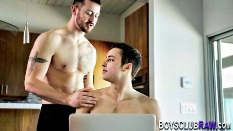 Tattooed muscular hunk touches young twink's bare shoulder shirtless in gay kitchen tease