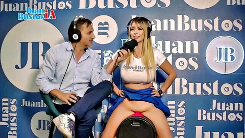 Blonde babe spreads legs flashing shaved pink pussy on radio host's lap