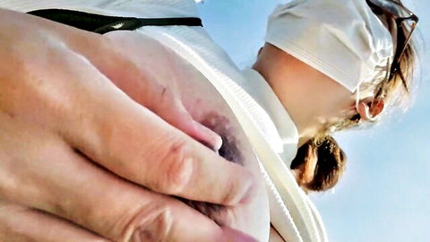 Blonde mature woman exposing large bare breast outdoors, masturbation tease
