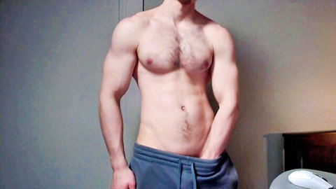 Muscular hairy white guy teasing bulge in low sweatpants