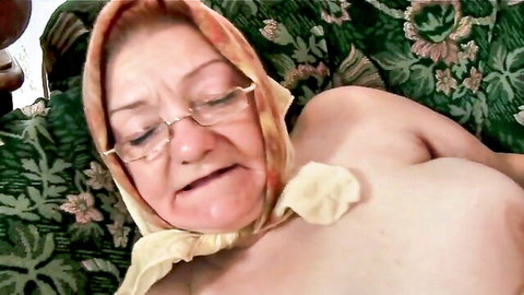 Grandma Dominika mature nude, glasses and headscarf, rubbing on couch