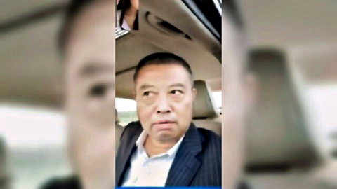 Blurry suited Asian DILF with open mouth in car driver's seat