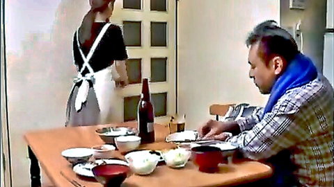 Japanese housewife in apron serves cuckold dinner to husband