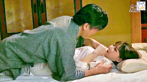 Japanese man passionately kissing woman's neck from behind in bed while fondling her in yukata
