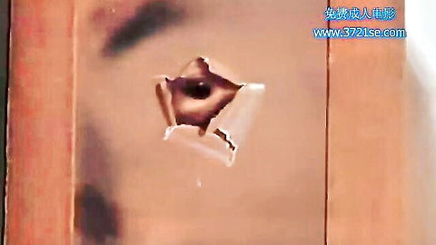 Chinese woman peeking through door hole in voyeur adult scene