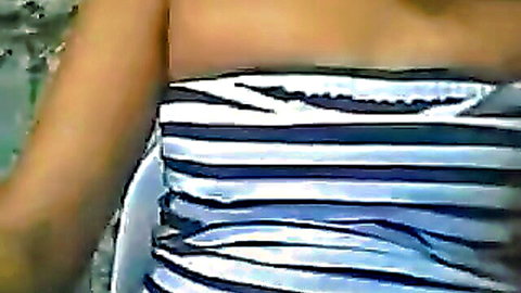 Filipino MILF with big tits squeezed in tight striped bikini top showing deep cleavage