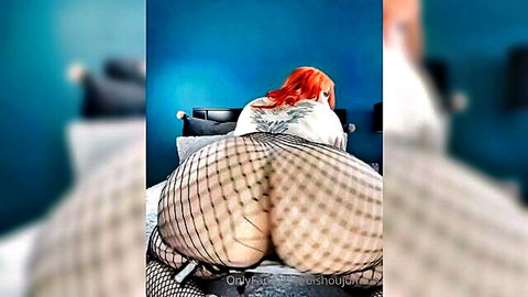 Redhead with massive ass in fishnet stockings, seductive pose